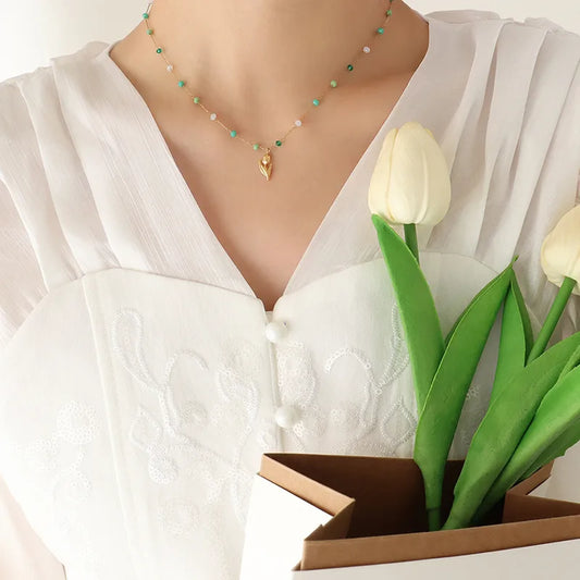Golden chain with green beads
