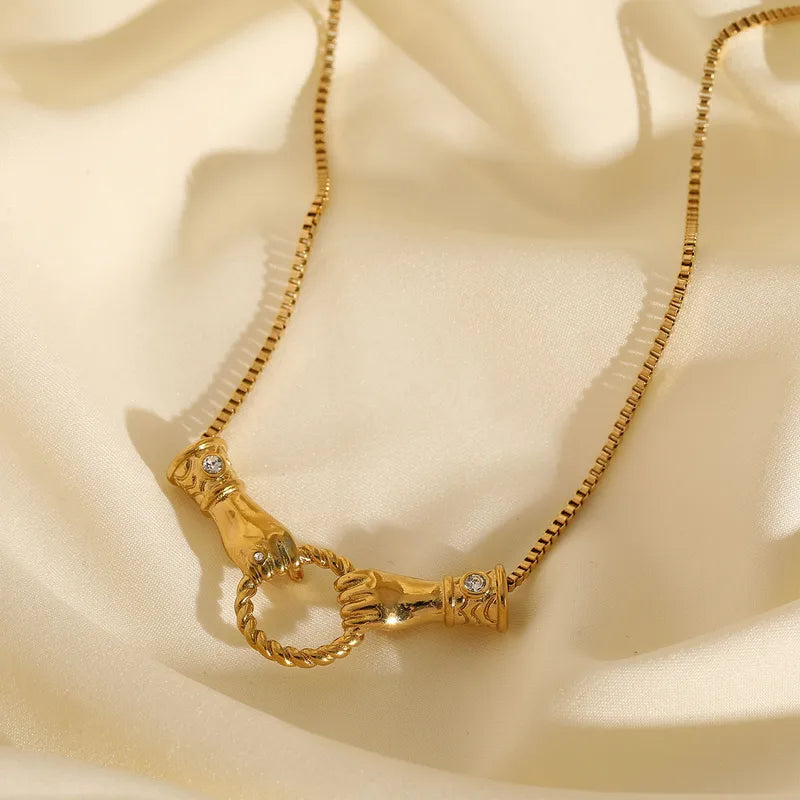 Golden hands necklace