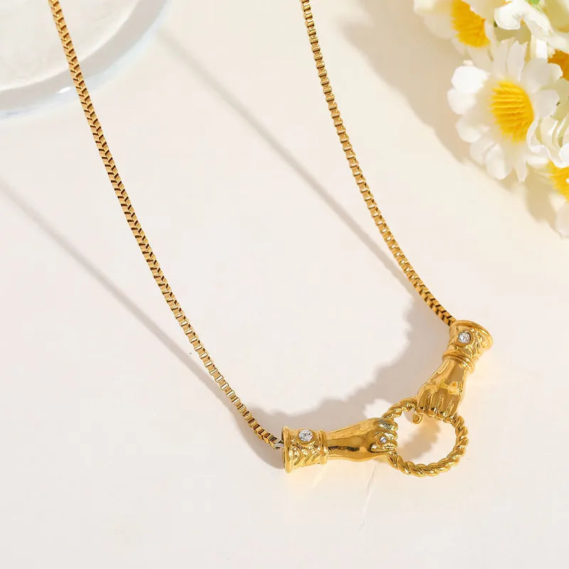 Golden hands necklace